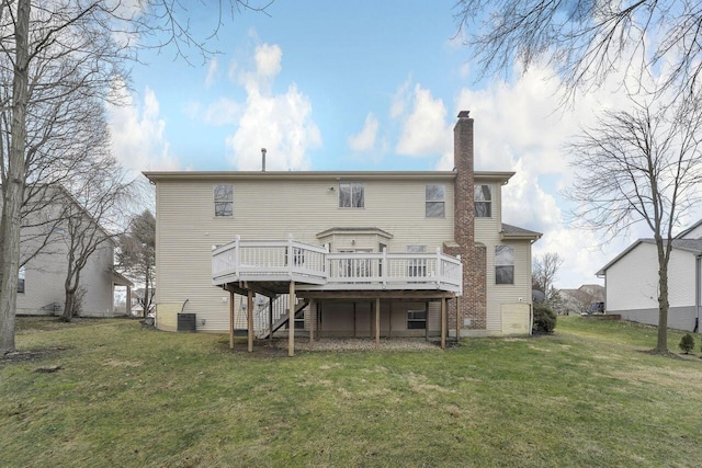 rear view of house featuring a wooden deck, central AC, and a lawn