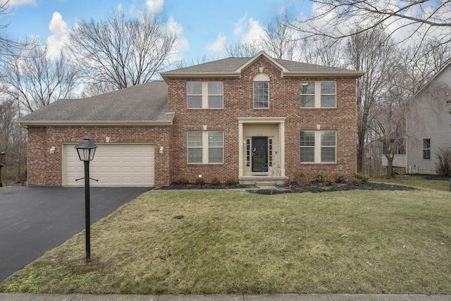 view of front of property featuring a garage and a front yard