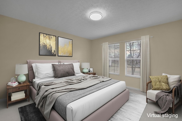 bedroom with light colored carpet and a textured ceiling