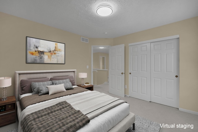 carpeted bedroom with a closet and a textured ceiling