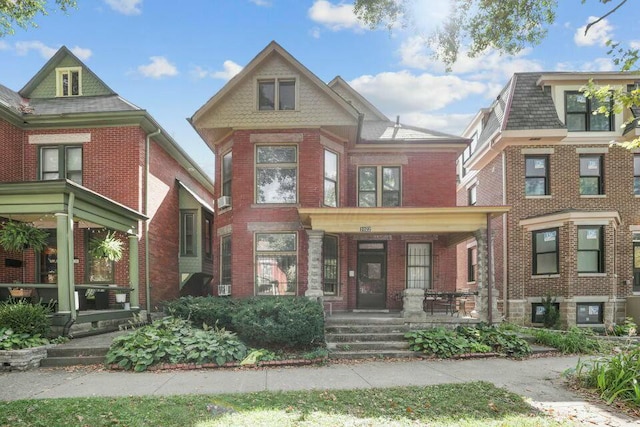 view of front of property with covered porch and brick siding