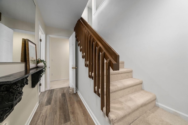 stairs featuring baseboards and wood finished floors