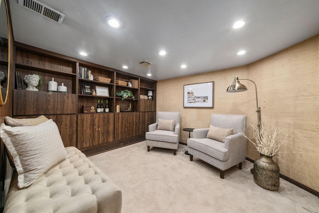 sitting room with recessed lighting, visible vents, and light carpet