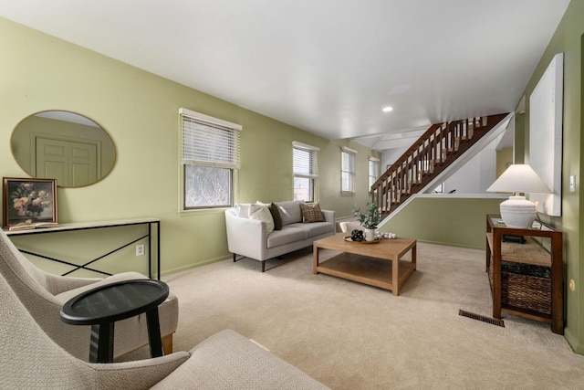 living area featuring recessed lighting, visible vents, light carpet, baseboards, and stairs