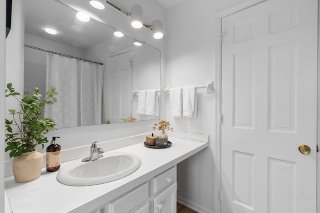 full bathroom with a shower with curtain and vanity