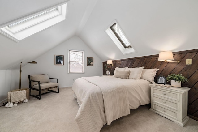 bedroom with vaulted ceiling with skylight and light colored carpet