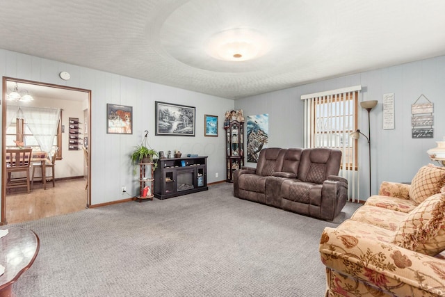 carpeted living room featuring a healthy amount of sunlight and a fireplace