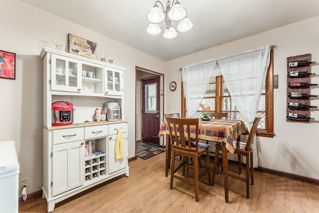 dining room with a notable chandelier and light hardwood / wood-style flooring