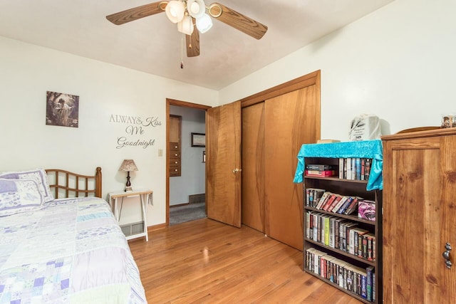 bedroom featuring ceiling fan, a closet, and light hardwood / wood-style flooring