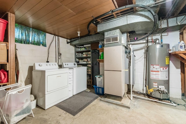 basement featuring heating unit, washer and dryer, and gas water heater