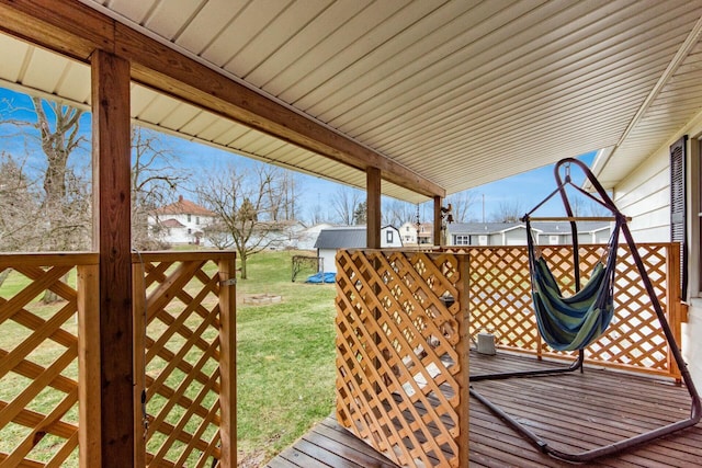 wooden terrace featuring a yard