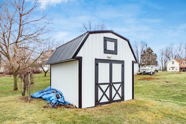 view of outbuilding featuring a lawn