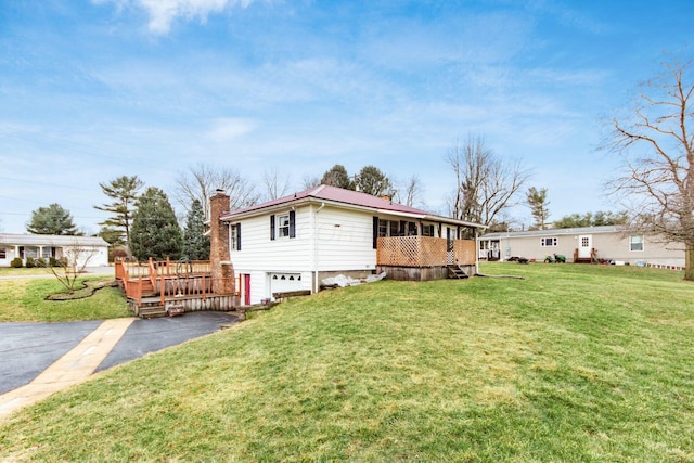 view of side of property with a deck and a lawn