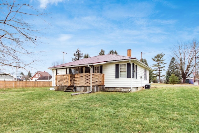 rear view of house featuring a lawn