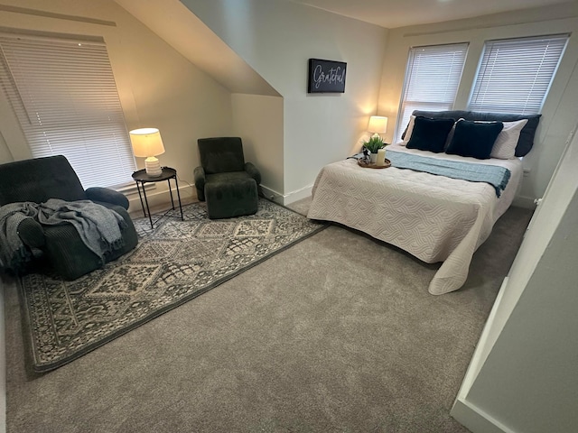 carpeted bedroom featuring lofted ceiling