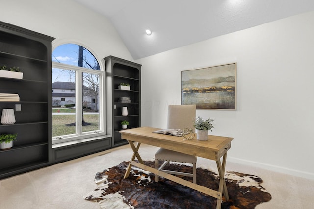 office space featuring light carpet and lofted ceiling