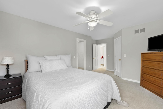 bedroom with visible vents, baseboards, light colored carpet, and a ceiling fan