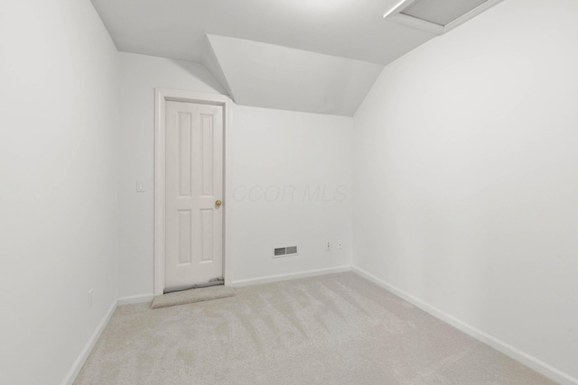 bonus room with visible vents, baseboards, light colored carpet, and vaulted ceiling