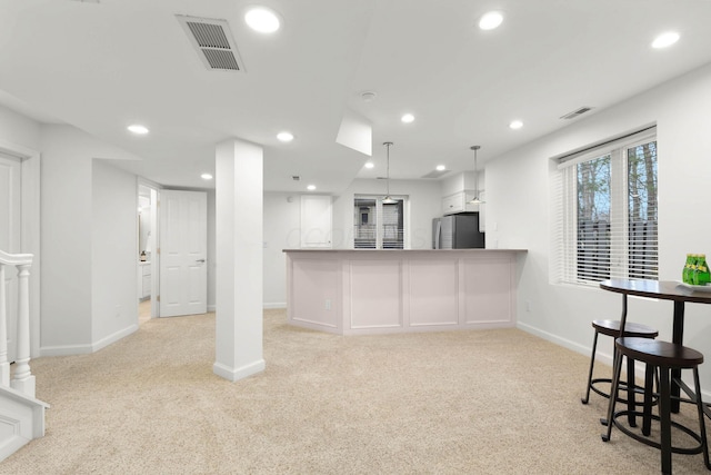 kitchen with light colored carpet, recessed lighting, visible vents, and freestanding refrigerator