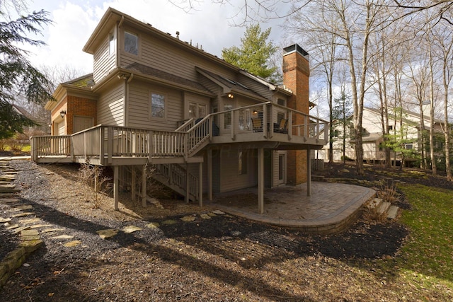 back of house featuring a patio area, a chimney, stairs, and a deck