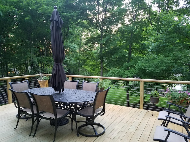 wooden terrace with outdoor dining area