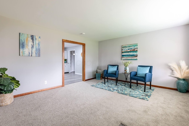 sitting room with carpet flooring and baseboards