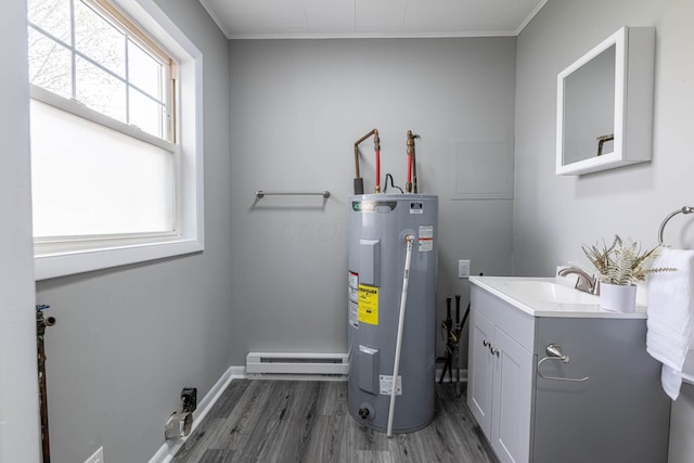 utility room with a baseboard heating unit, electric water heater, and a sink
