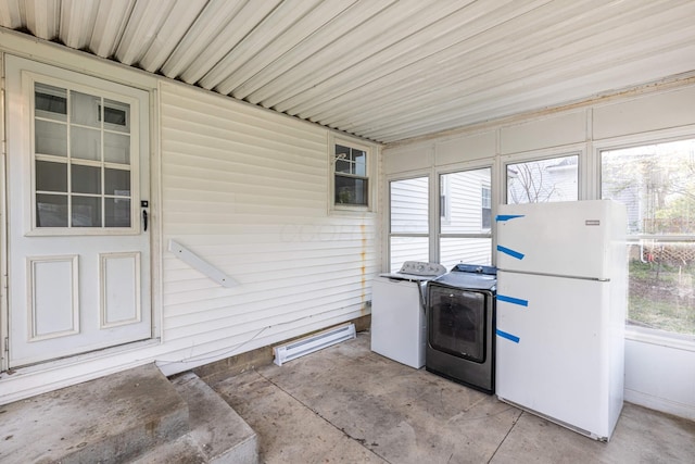 unfurnished sunroom with washing machine and clothes dryer