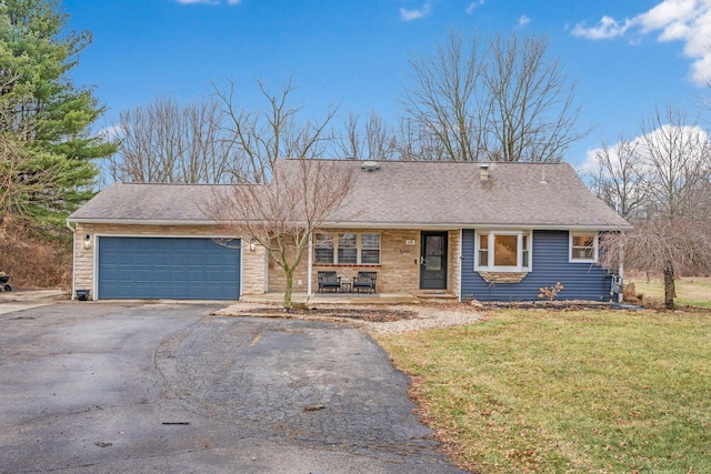 ranch-style home with a garage and a front lawn