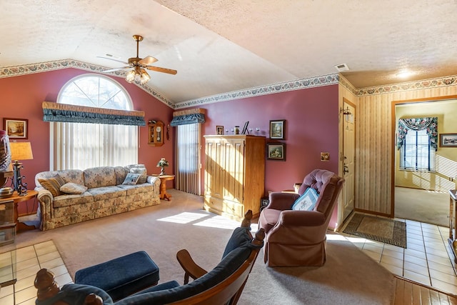 carpeted living room with ceiling fan, lofted ceiling, and a textured ceiling