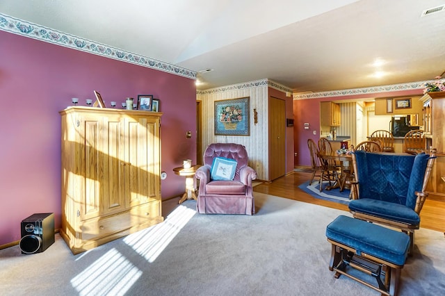 sitting room featuring lofted ceiling and carpet flooring