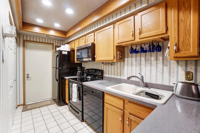 kitchen with sink, a textured ceiling, light tile patterned floors, a tray ceiling, and black appliances