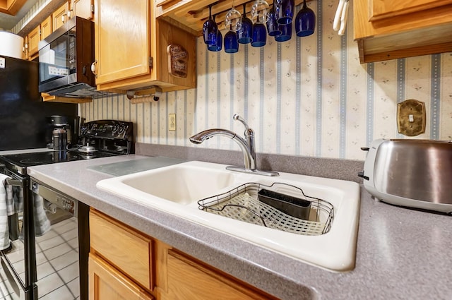 kitchen featuring sink, light tile patterned floors, and black appliances