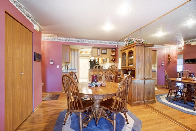 dining area with light hardwood / wood-style floors