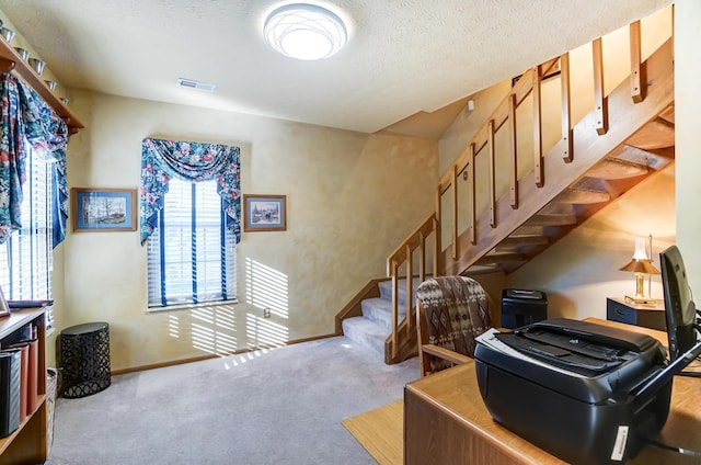 stairs with carpet flooring and a textured ceiling