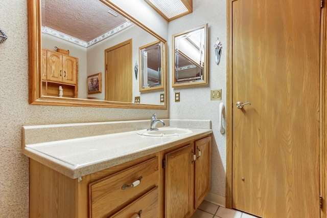 bathroom with vanity, tile patterned flooring, and a textured ceiling