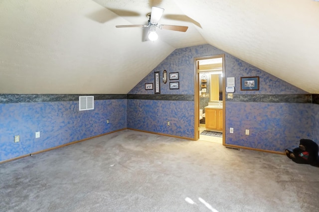 bonus room featuring lofted ceiling, ceiling fan, and carpet flooring