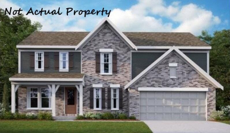 view of front of house with a garage and a front yard