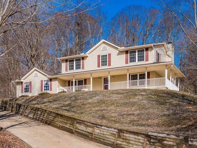 view of front of home with covered porch and a front yard