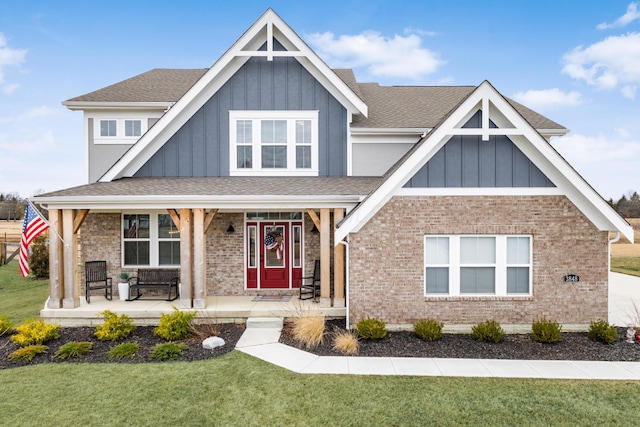 view of front of home featuring a front yard and covered porch