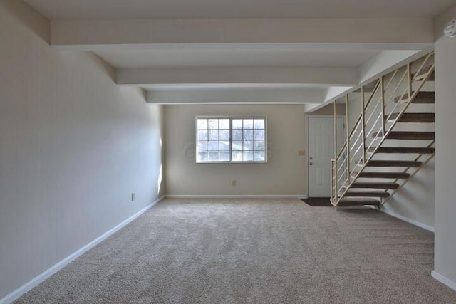 empty room with beam ceiling and carpet