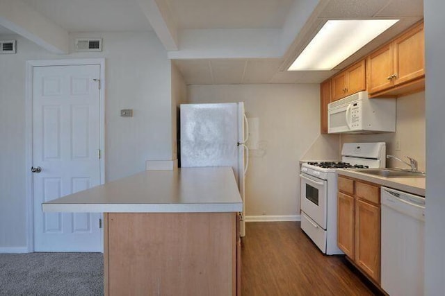 kitchen featuring beamed ceiling, white appliances, a center island, and sink