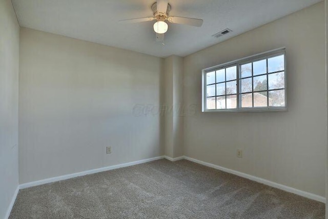 carpeted spare room with ceiling fan