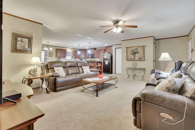 carpeted living room with crown molding, ceiling fan with notable chandelier, and a textured ceiling