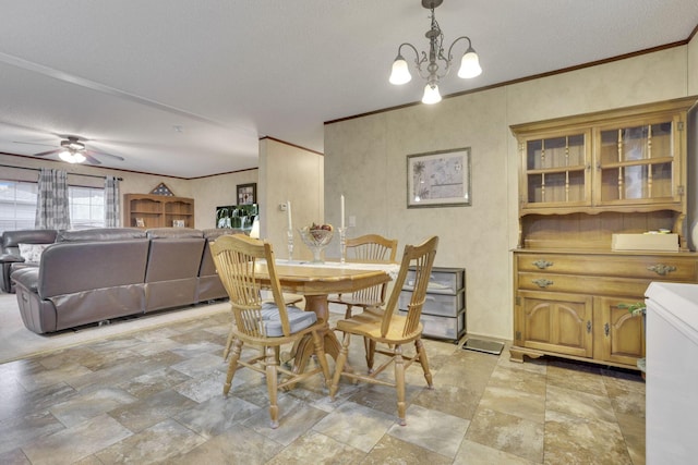 dining room featuring crown molding and ceiling fan with notable chandelier