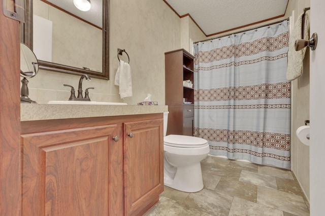 bathroom with crown molding, vanity, a textured ceiling, and toilet