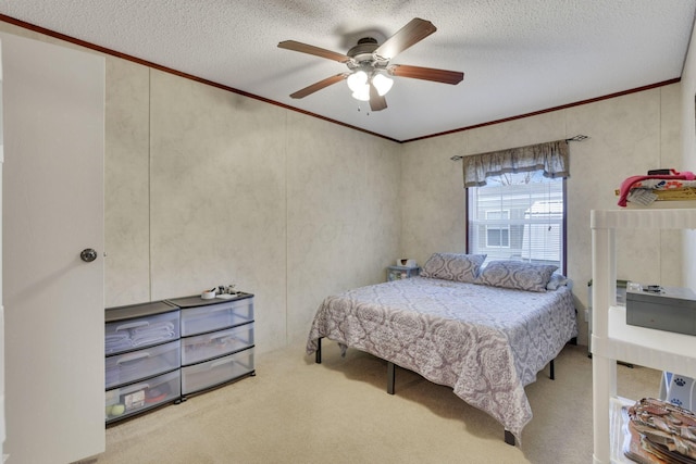 carpeted bedroom with crown molding, ceiling fan, and a textured ceiling