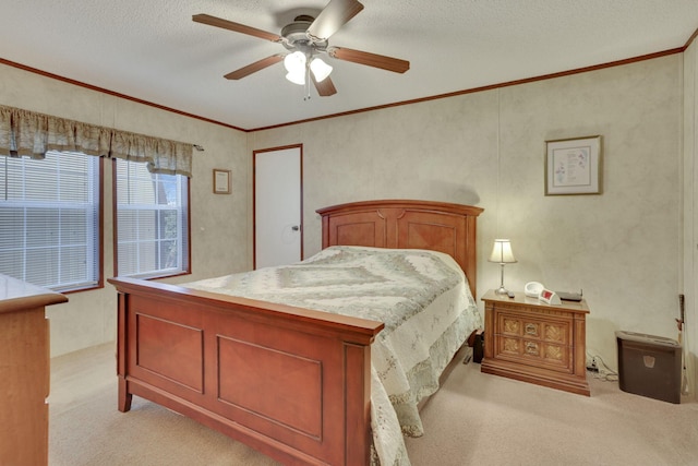 carpeted bedroom featuring ceiling fan, crown molding, and a textured ceiling