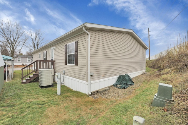 view of property exterior featuring cooling unit and a lawn