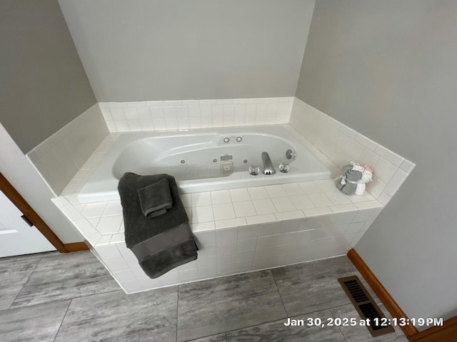 bathroom featuring tiled bath